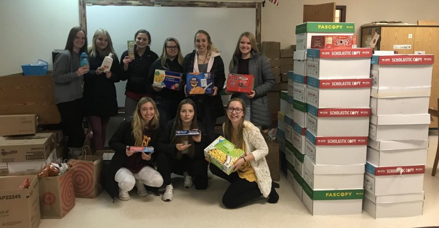 Student Council members show off the food they collected during the food drive.